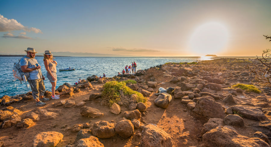 Couple hiking in the Galapagos National Park during sunset
