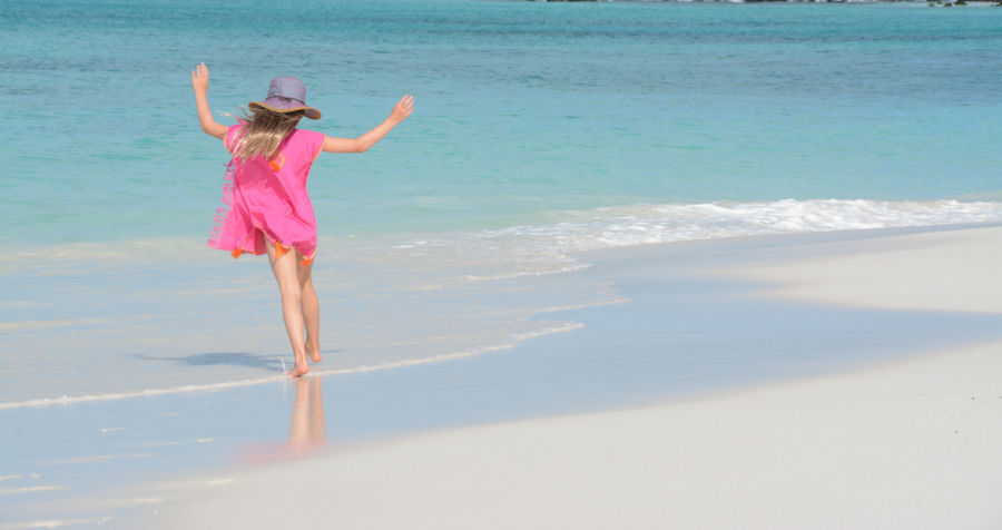 Una niña disfruta de la playa en Isla Española, Galápagos