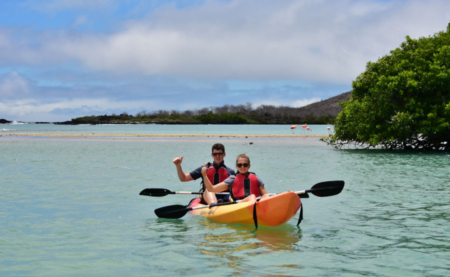Couple rides around Post Office Bay on a Kayak in the Galapagos