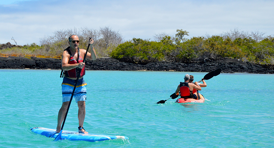Exploring the clear blue waters of the Galapagos shoreline by paddleboard