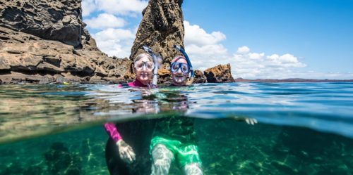 Senior travelers snorkeling in the Galapagos Islands