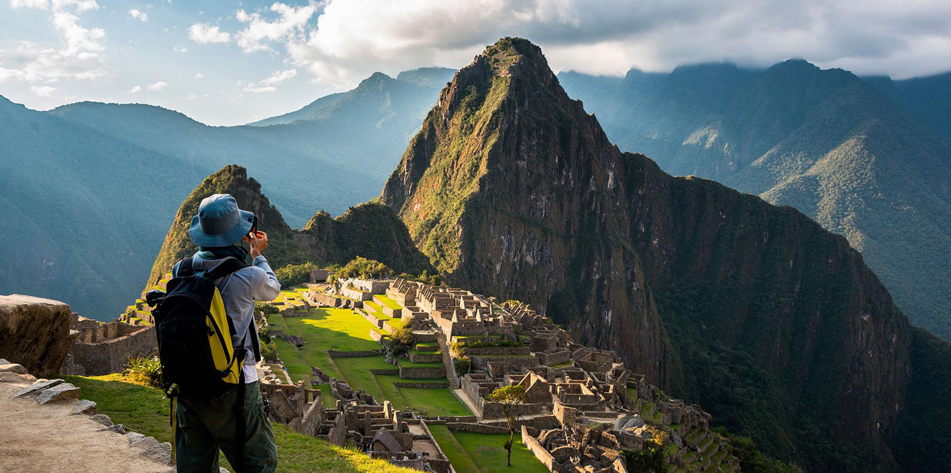 Tourist photographing Machu Picchu ancient Inca citadel