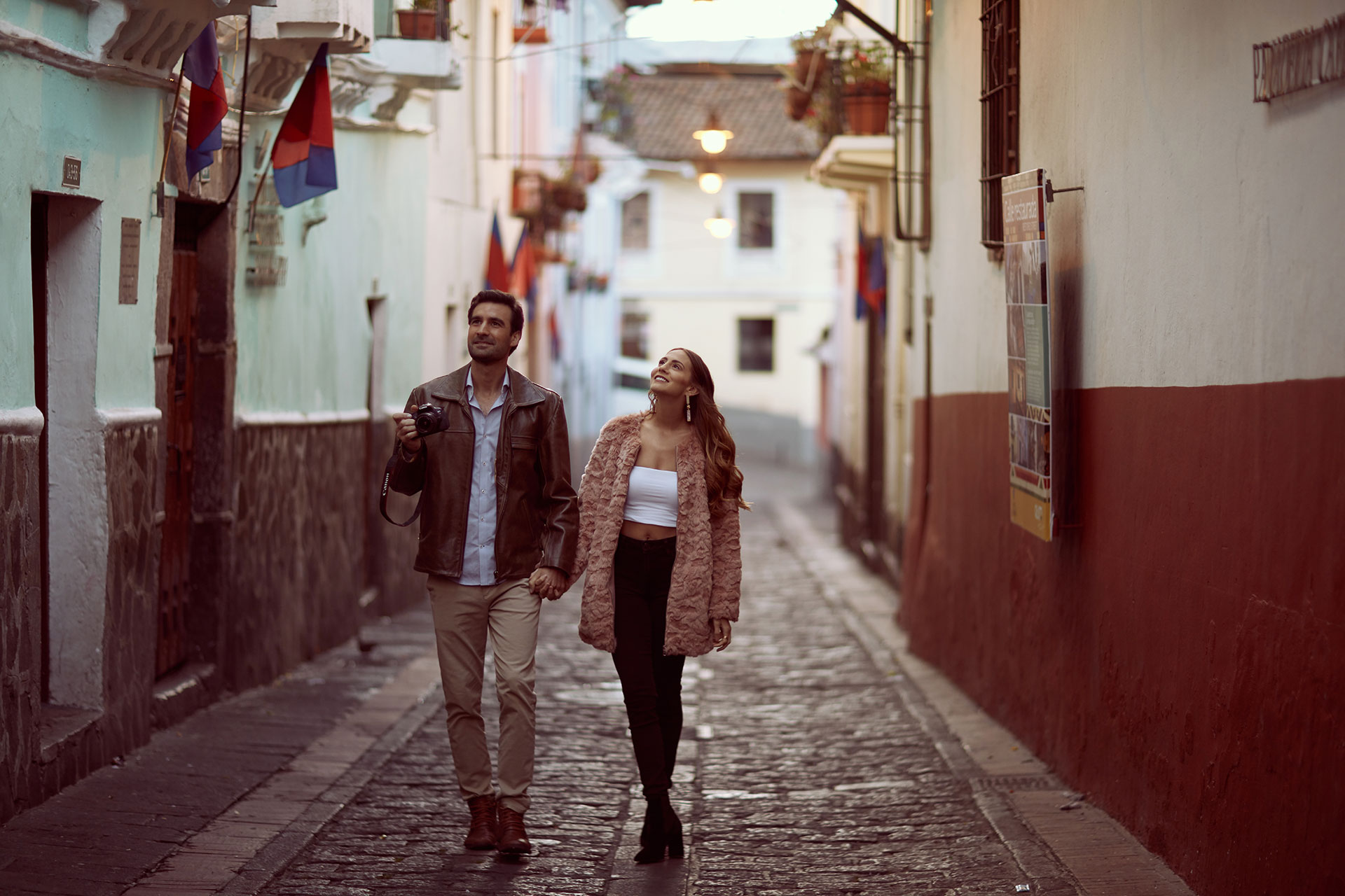 Couple exploring La Ronda street in Quito, Ecuador