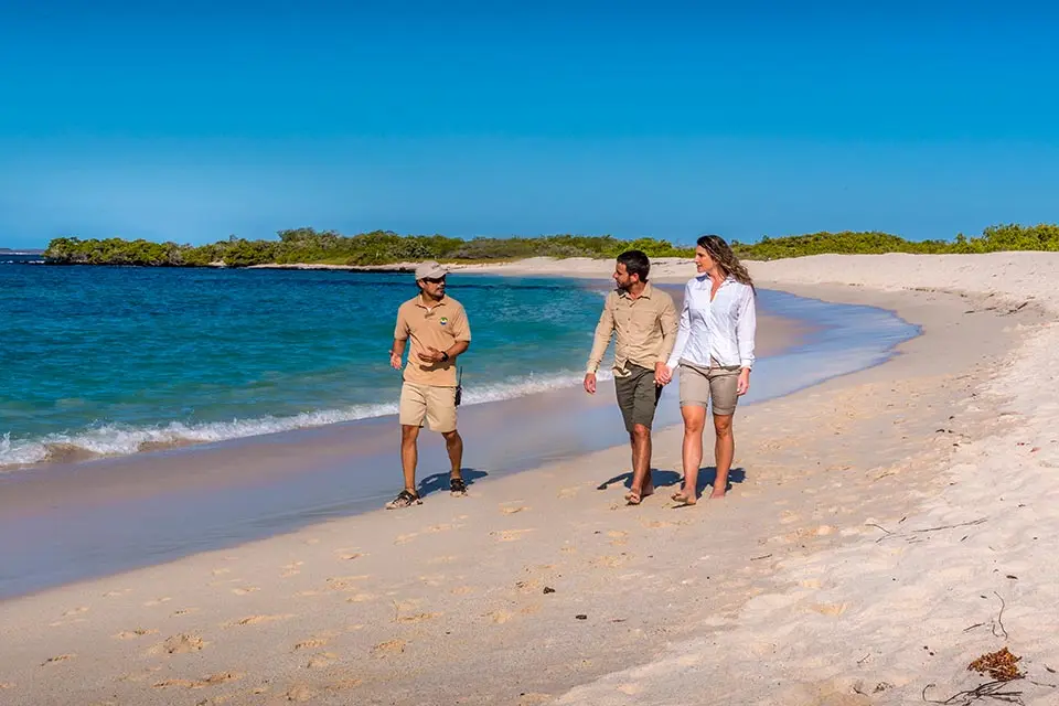 Couple of visitors with naturalist guide in Galapagos Islands