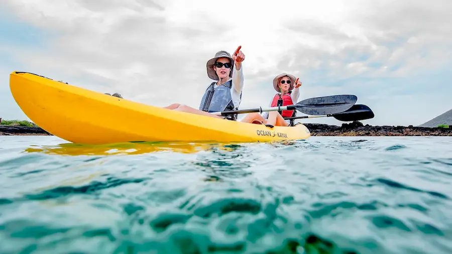 Couple of women kayaking and admiring the view in Galapagos